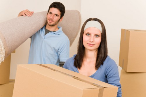 Professional movers loading furniture into a removals van