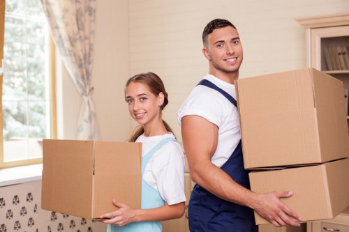 Professional movers loading items into a removals van