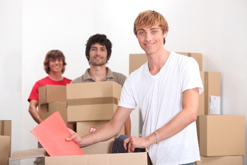 Smiling moving team handling belongings